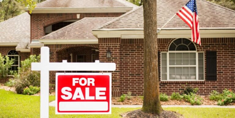 for sale sign in front of house